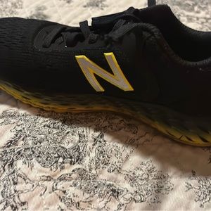 Boys  Toddler size 11 New Balance tennis shoes. Black and yellow.